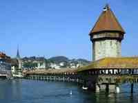 Luzern's Reuss River is spanned by the wooden Chapel Bridge, with its iconic stone water tower.