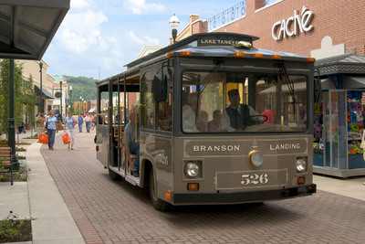 Branson Landing Trolley makes its way north up the Promenade at Branson Landing.  Branson, MO, USA