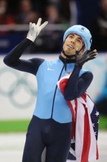 2010 Vancouver Winter Olympic Games: VANCOUVER, BC - FEBRUARY 20: Apolo Anton Ohno of the United States holds up seven fingers to signify his seven Olympic medals after winning bronze during the Short Track Speed Skating Men's 1000m Final on day 9 of the Vancouver 2010 Winter Olympics at Pacific Coliseum on February 20, 2010 in Vancouver, Canada. Photo by: Paul Drinkwater/NBC
