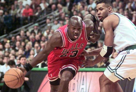 Chicago Bulls guard Michael Jordan drives past Ron Mercer of the Boston Celtics.