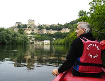 Canoeists get a dramatic view of the French village of Beynac as it tumbles down a steep hill from its majestic castle to the Dordogne River