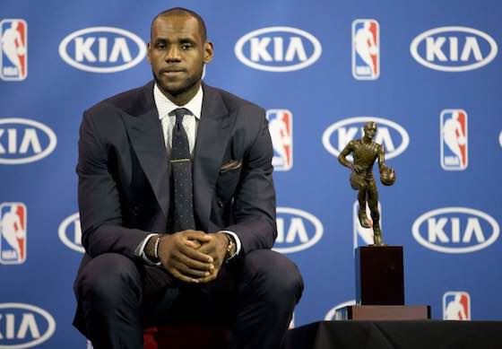 LeBron James sits with his MVP trophy during a news conference in 2013.