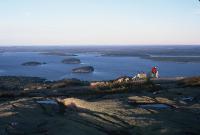 Sunset atop Cadillac Mountain -- the first place the sun hits in North America at sunrise. Dotted Island in the bay in the background. Maine Acadia National Park