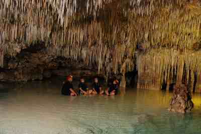 Sitting cross-legged in the water, 60 feet underground in a Mexican cenote.