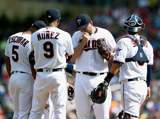 Minnesota Twins teammates huddle around Kevin Jepsen on the mound during a June 5 loss against the Tampa Bay Rays.