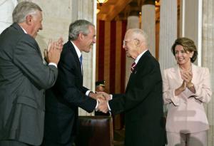 President George W. Bush along with House Majority Leader Steny Hoyer and House Speaker Nancy Pelosi congratulate Borlaug during the Congressional Gold Medal Ceremony on July 17, 2007