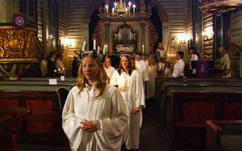 Norwegian girls celebrate the feast of Santa Lucia on Dec. 13 with a candlelight procession