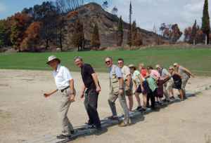 Visitors in ancient Olympia line up at the original starting block for the first Olympics