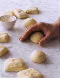 On a floured surface, roll each rounded wedge of dough under your palm to stretch a smooth and even skin all around (step 5)