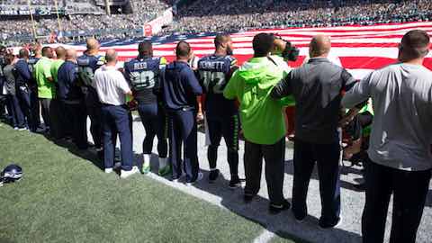 Seahawks players, coaches and staffers locked arms during the national anthem as a gesture of unity. (Drew McKenzie, Sportspress Northwest)