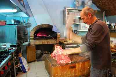 The chef at this Tuscan restaurant doubles as a butcher -- he cuts the steak before he grills it