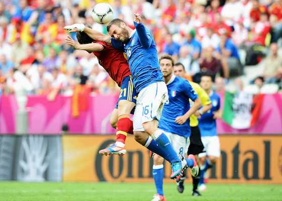 	GDANSK, POLAND - JUNE 10: David Silva of Spain and Daniele De Rossi of Italy jump for the ball during the UEFA EURO 2012 group C match between Spain and Italy at The Municipal Stadium on June 10, 2012 in Gdansk, Poland. (Photo by Claudio Villa/Getty Images)