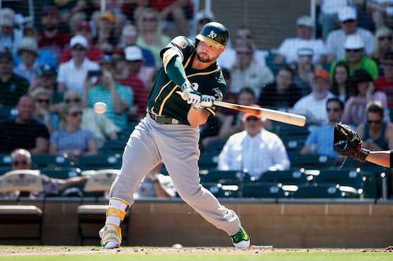 Yonder Alonso of the Oakland Athletics bats against the Arizona Diamondbacks during spring training.